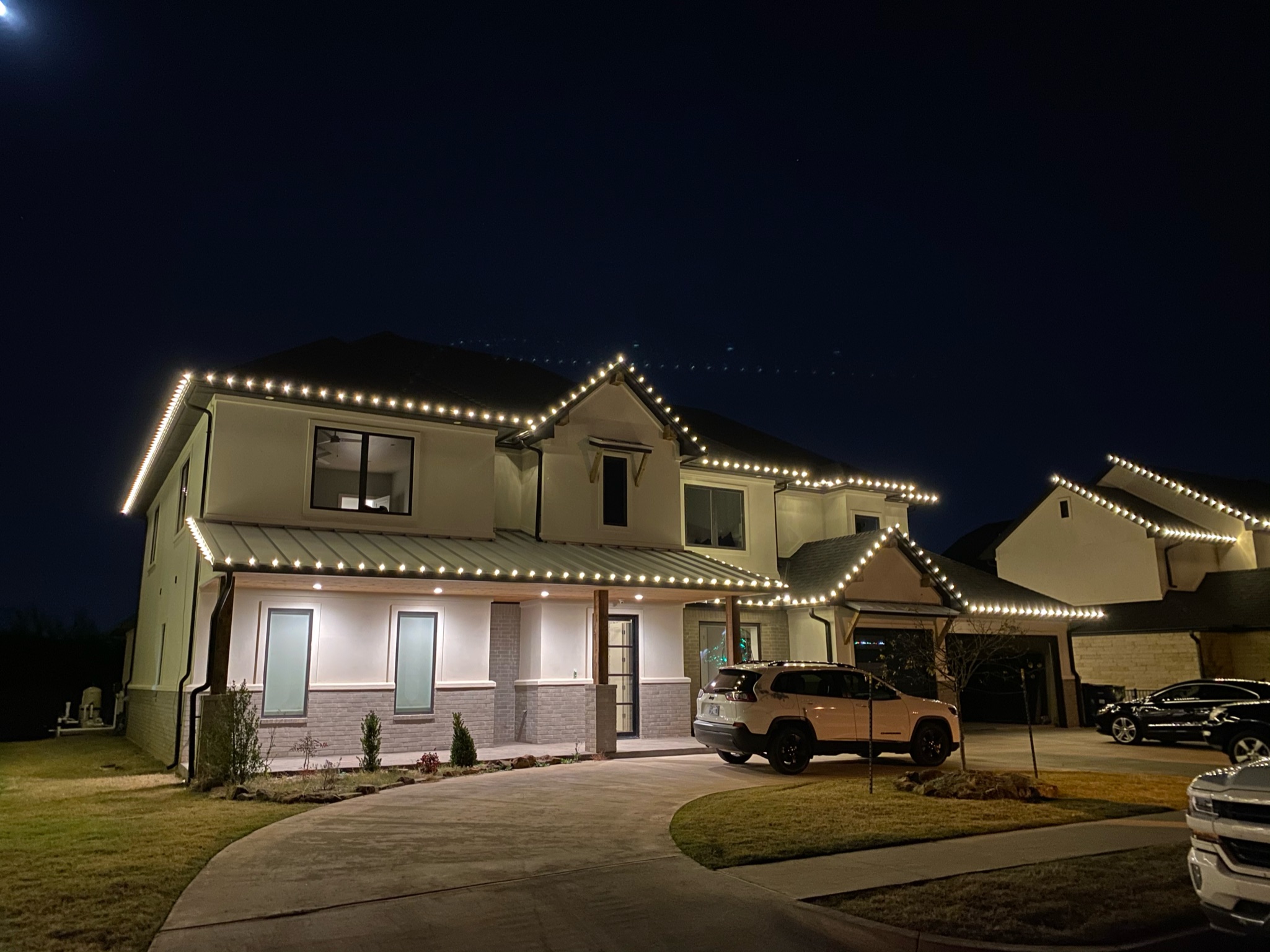 Clean roofline warm white Christmas lights professionally installed demonstrating our quality work in Norman, Oklahoma
