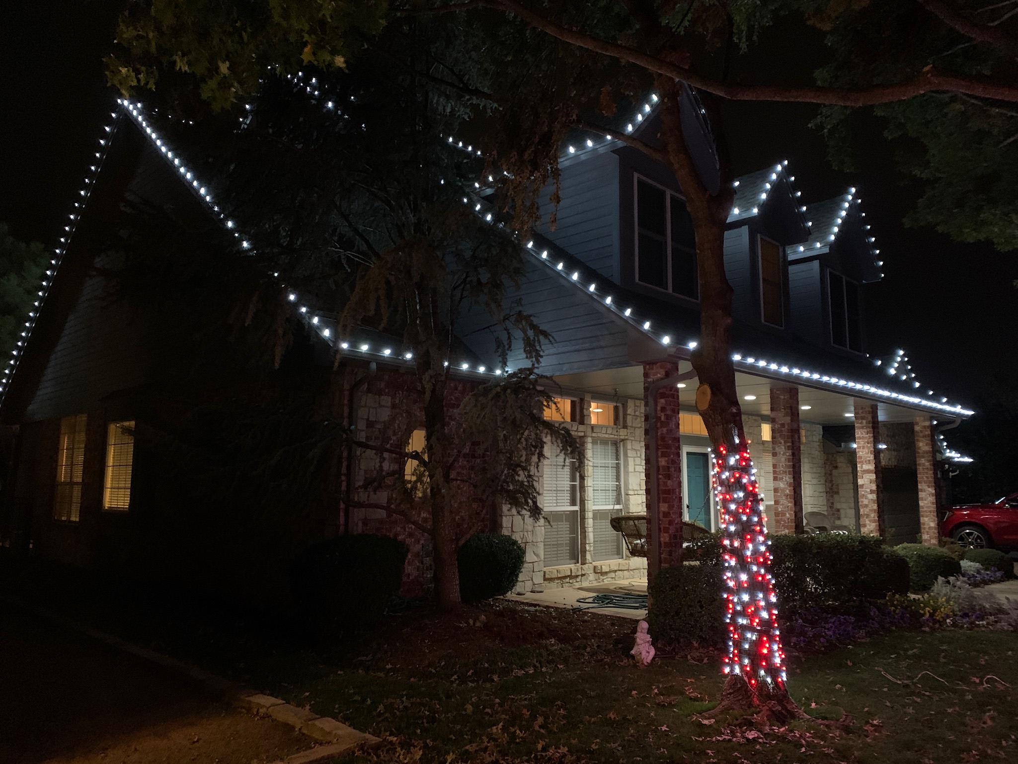 Tree wrap and roofline Christmas lights installation showing our lighting services in Edmond